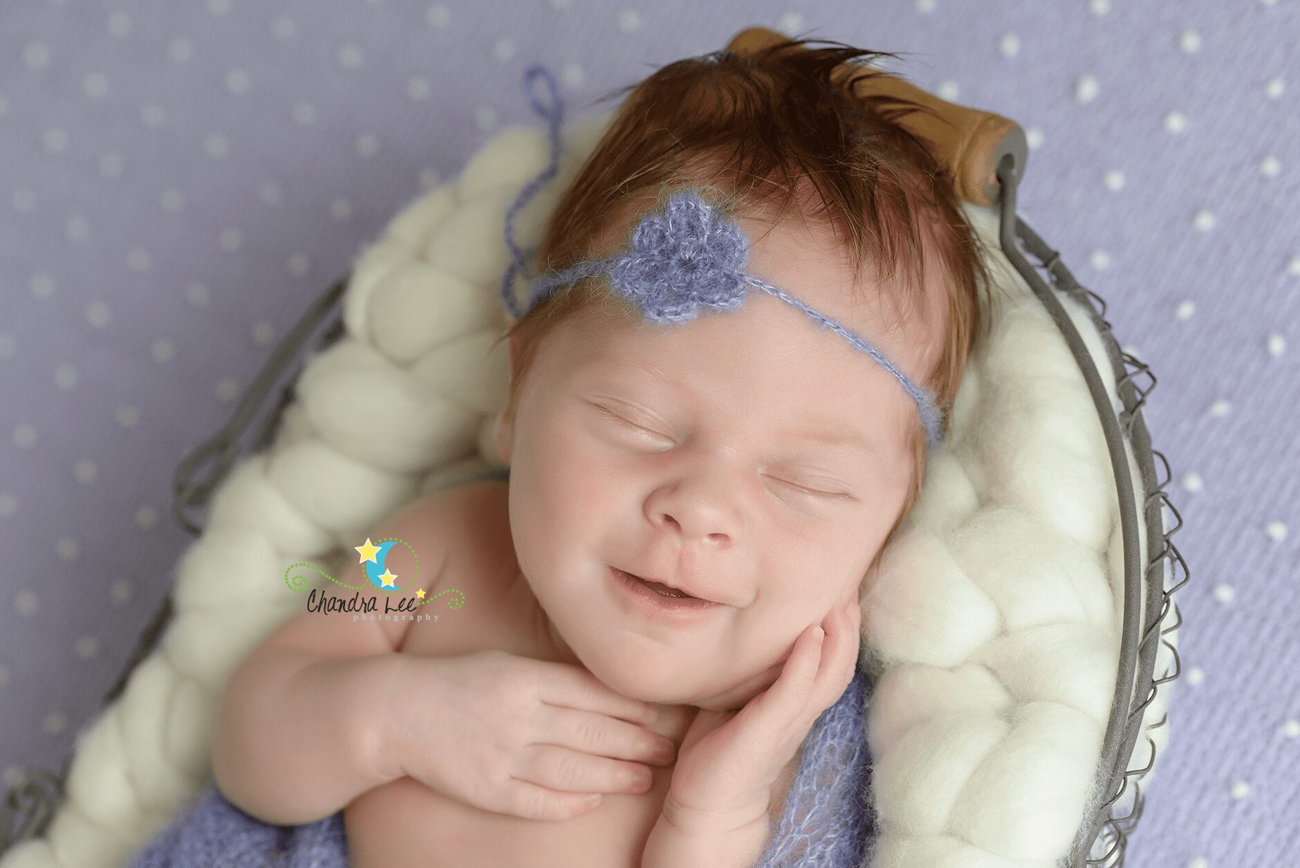 Picture of Baby Charlotte Smiling on Purple Backdrop
